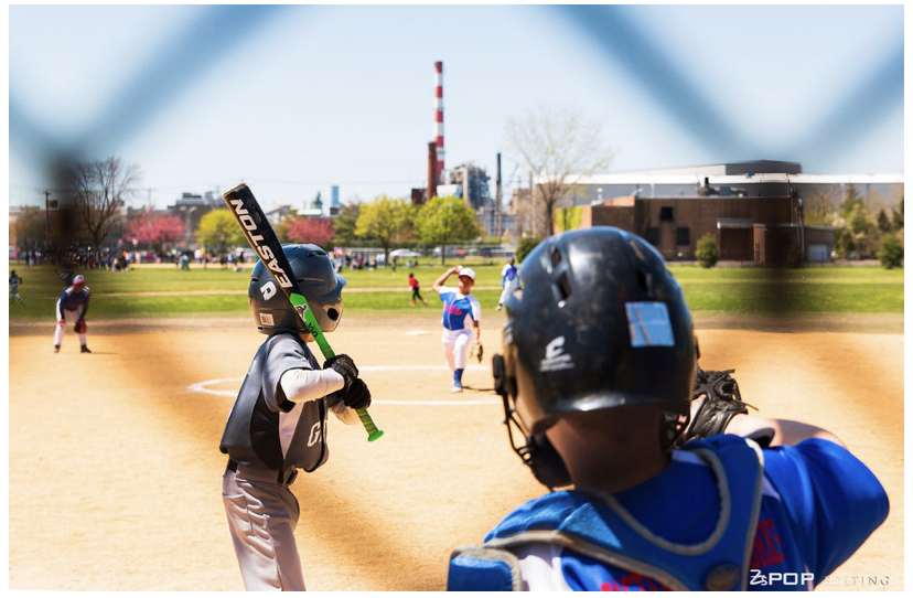Youth sports baseball player at bat ready to hit a baseball on a baseball field for Newfield Little League in East Bridgeport Connecticut with the All Kids Play financial assistance grant