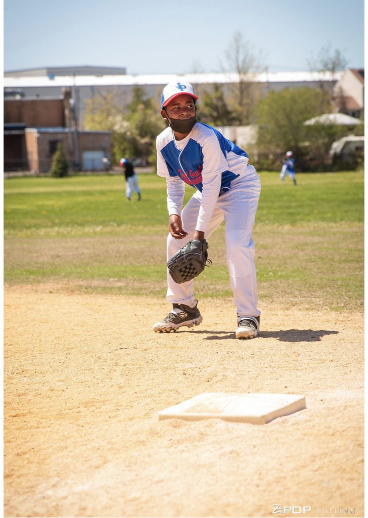 Youth sports baseball player ready to field ball on baseball field for Newfield Little League in East Bridgeport Connecticut with the All Kids Play financial assistance grant
