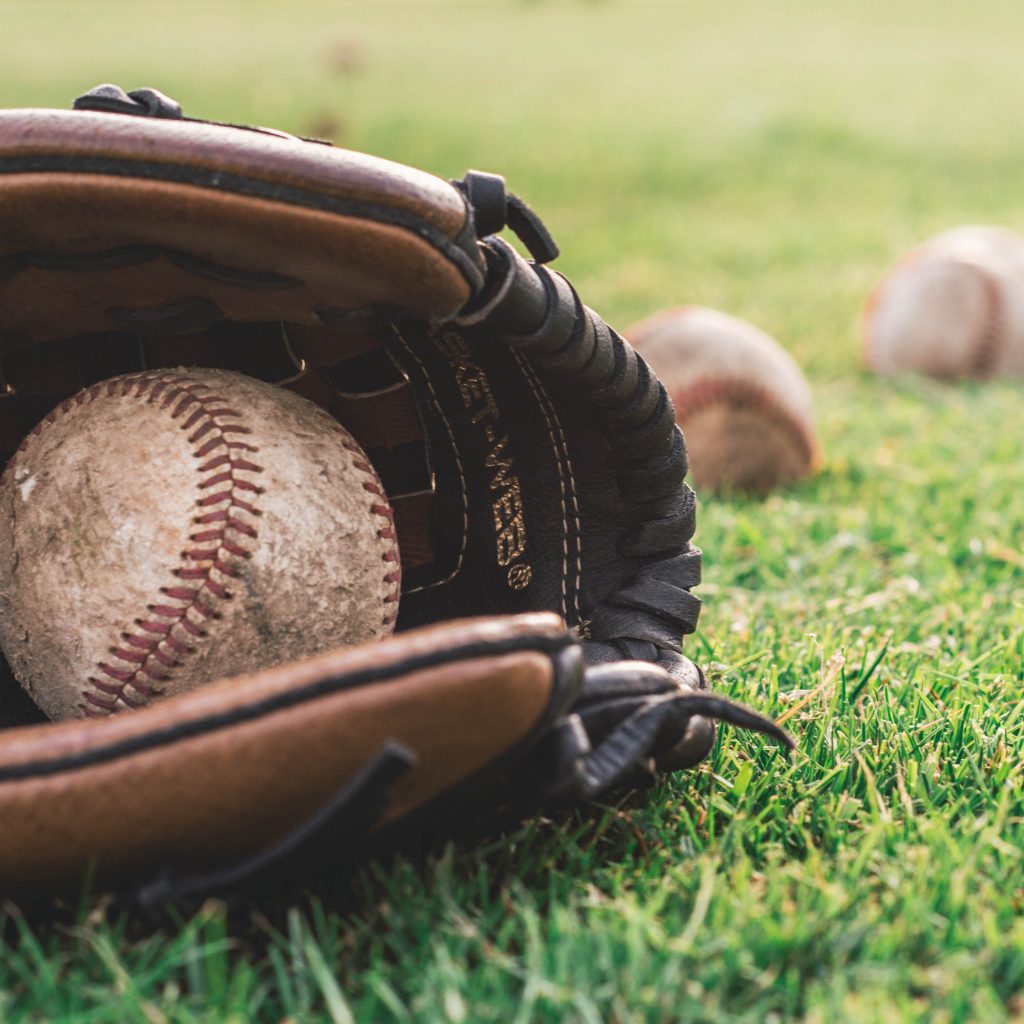 Baseball and baseball glove on a field